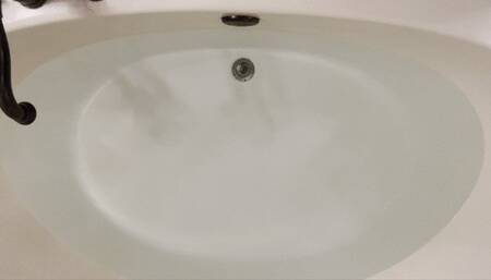 Carissa in scrubs and Cloud shoes in the bathtub--a mermaid just needs water!