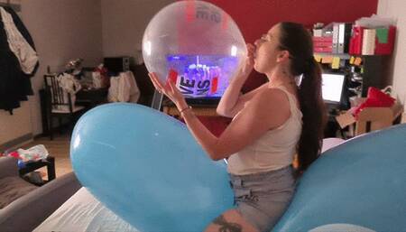 Sophie blows balloons and inflate to pop some