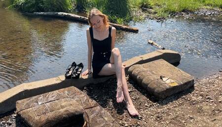 a girl walks along the beach in shoes, she wants to go home, but she cannot climb a mountain in shoes, because mud and sand slide