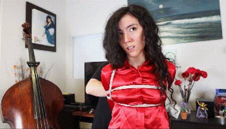 Khrystal in red satin and jeans is being held for ransom, tightly tied with ropes and ballgagged!