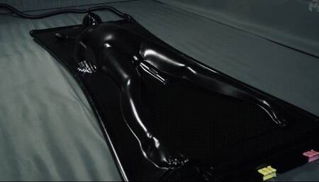 Orgasms in a black latex bed with a pear gag