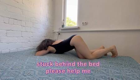 stuck behind the bed