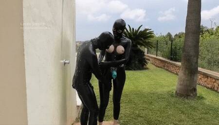 Strap-on fuck under the outdoor shower