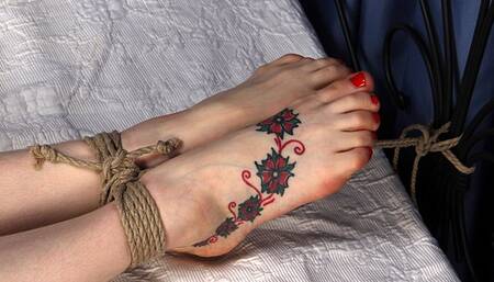 Ballgagged barefoot Amanda in red dress, bound on the bed with her hands tied to the headboard and with her feet tied to the footboard, is tickled by a man (HD MP4)