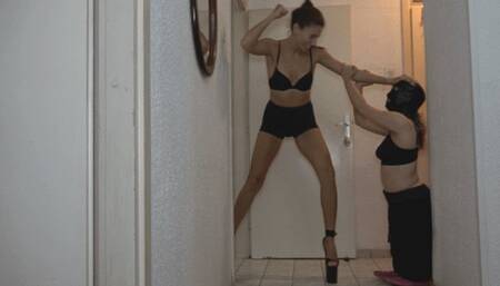 A midget woman and a tall woman are compared and played with height