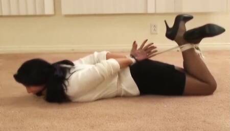 Gina Rae hogtied with palms facing out and gagged with a ball inside a stocking