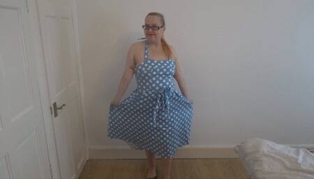 striptease in 50's dress with stockings and suspenders