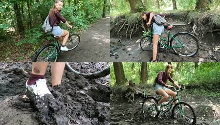 Nastya on a bicycle stuck in deep mud