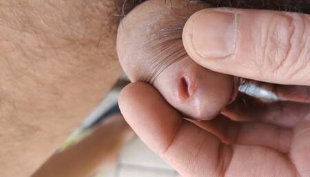 Squeezing my peehole, sitting naked outdoors