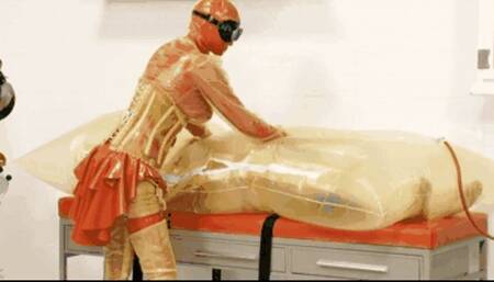 Fetish rubber couple in medical clinic - Part 1 of 2 - The inflatable cocoon