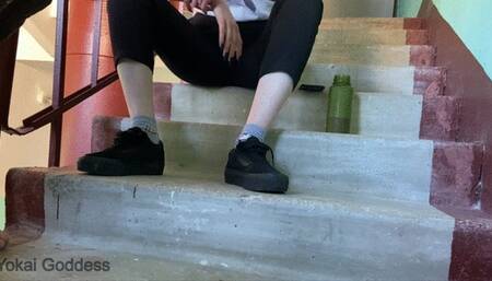 Dirty Vans shoe soles licking in tha public stairs