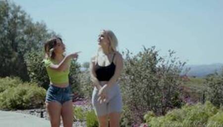 Slimthic Vic and Chanel Camryn on a grey sofa in several lesbian scenes together