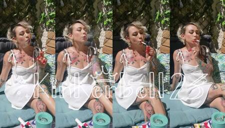 Chain-smoking outdoors in short White dress