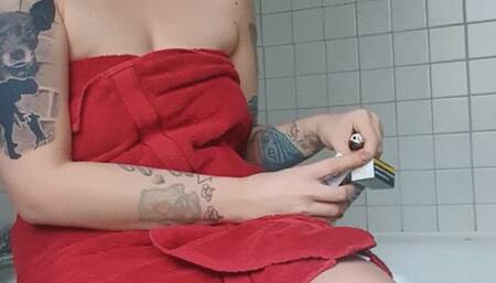 Sitting on the Bathtub just with a towel and enjoy Smoking