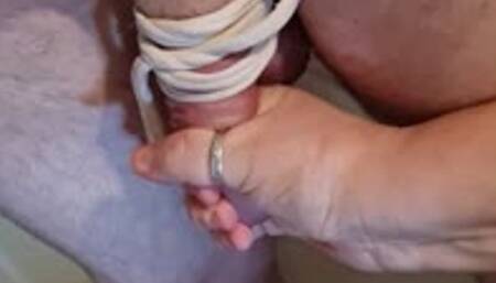 Handjob on naked man tied to stairs