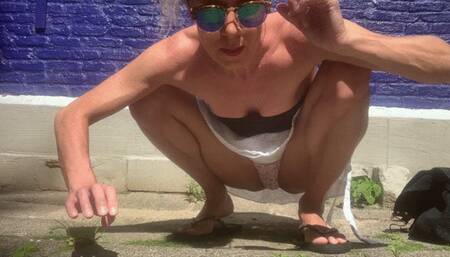 Squatting pose by painted wall