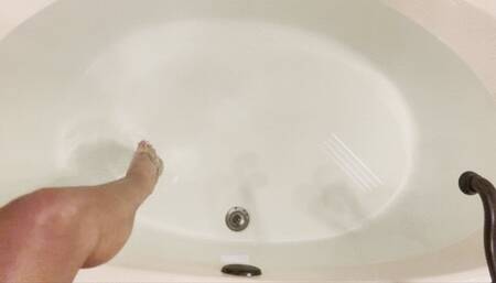 Cariss in the sheer bodysuit in the bathtub with the metal tickler sensual touch