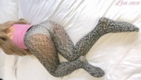 Sexy blond girl is playing her tablet and farting on leopard pantyhose