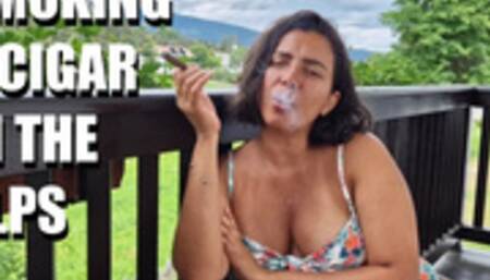 Hot MILF sensually smokes a cigar in the italians Alps