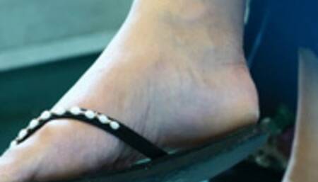 Dangling flip flops, nice feet close-up