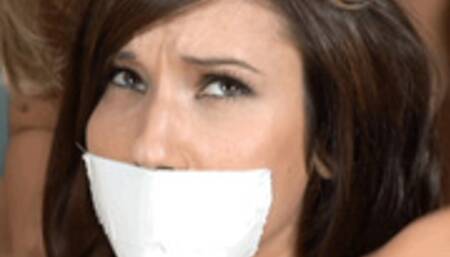 As Erin Avery lay bound and gagged on the floor, Kara Kingman played with her nearly nude body, then left Erin struggling!