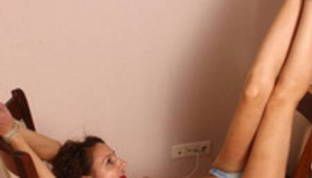 Gagged with red ball gag topless barefoot Ekaterina, wearing only polka dot panties, bound on two chairs in U-form, wiggles helplessly, unable to change her position (HD MP4)