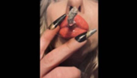 Dangling a full Marlboro 100