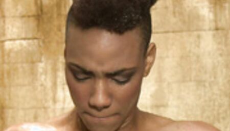 Ebony slave is sprinkled with water