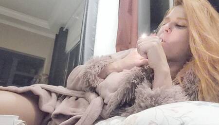 Smoking with dangling cigarette watching tv on couch