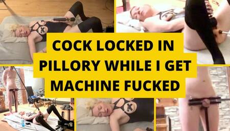 Cock locked in pillory while mistress gets machine fucked