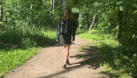 girl walking through the woods in high-heeled shoes and twisted her leg, she very hurt