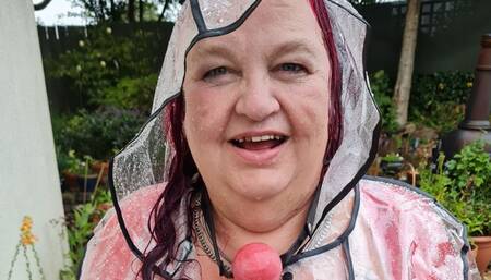 Miss M messing around in the rain in underwear and clear PVC rain coat- TopofthePot,BBW bondage,rainwear,plastic rain mac,ball gagged,woman gagged,women gagged,water,garden hose,ball gag