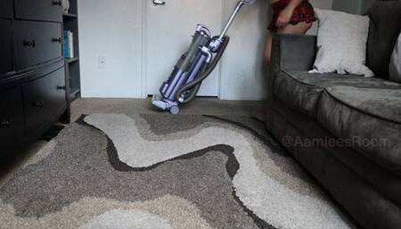 Vacuuming the carpet barefoot in a barely there miniskirt