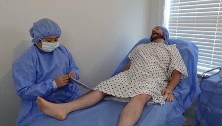 Doctor Jess wears surgical PPE and performs post orgasm torment procedure