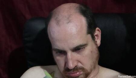 Shaving his head and trimming up his facial hair