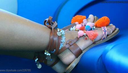 Rude girl with beauty feet puts her dirty colored sandal on train seat, candid foot and shoe fetish