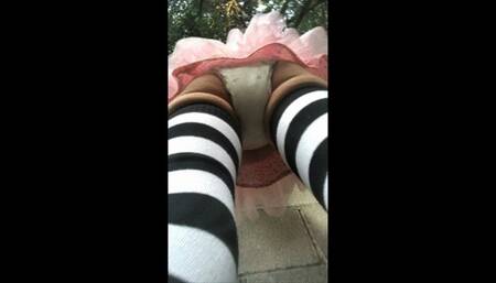 wetting pull-up in tutu and thigh-high socks outside