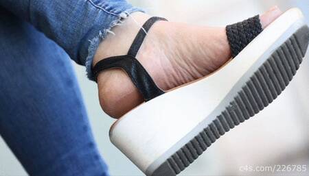 Candid beauty woman feet with wedges sandal heels under view