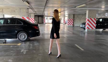 a girl in high-heeled shoes presses the pedals of the car, she changes her shoes and continues to play with the pedals