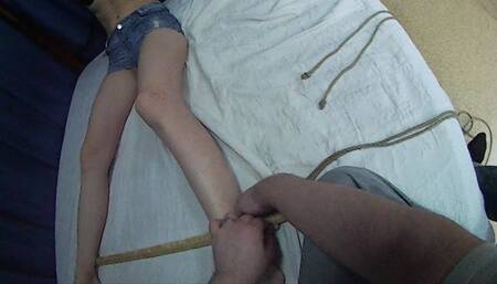 On-screen bondage: tying and gagging barefoot Sally in a balltie with her wrists tied to her ankles and bound to different ends of a wooden stick (HD MOV)