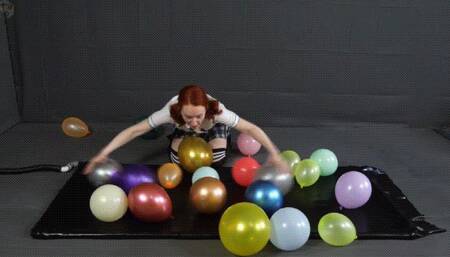Sonya balloons in a black latex bed