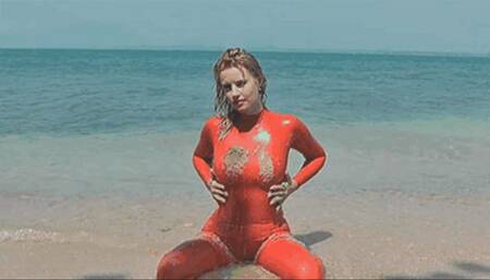 Red rubber latex catsuit mermaid has fun in sea and an the beach