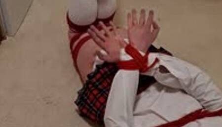 Man tied up in adult schoolgirl uniform 1