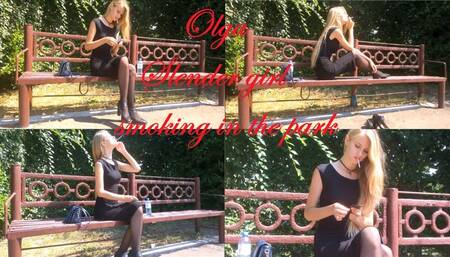Slender girl Olga smokes in the park