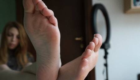 Beauty arrogance girl perfect feet and dirty soles, sensual slippers dangling with legs on table