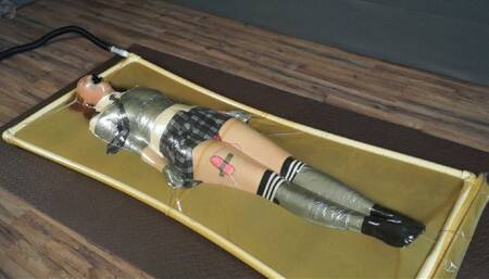 Schoolgirl bondage with duct tape and mini vibro in latex bed
