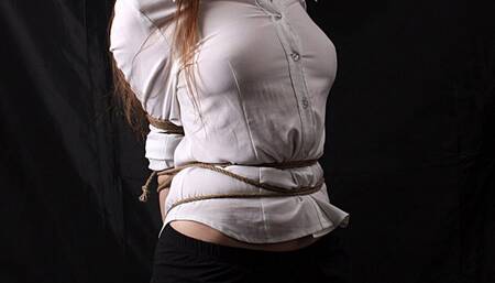 Ballgagged Amanda, wearing shirt, panties and high heels, bound kneeling to the pole on the pad, is wiggling in her ropes, then tickled and teased by her friend (HD WMV)