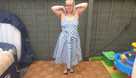 striptease in 50s blue dress with nylon stockings and suspenders