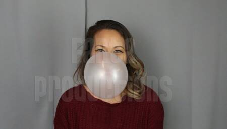 Jane Domino Blowing Bubbles in Red Sweater