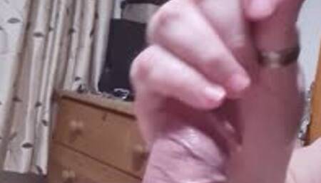 Handjob on a spreadeagled naked man